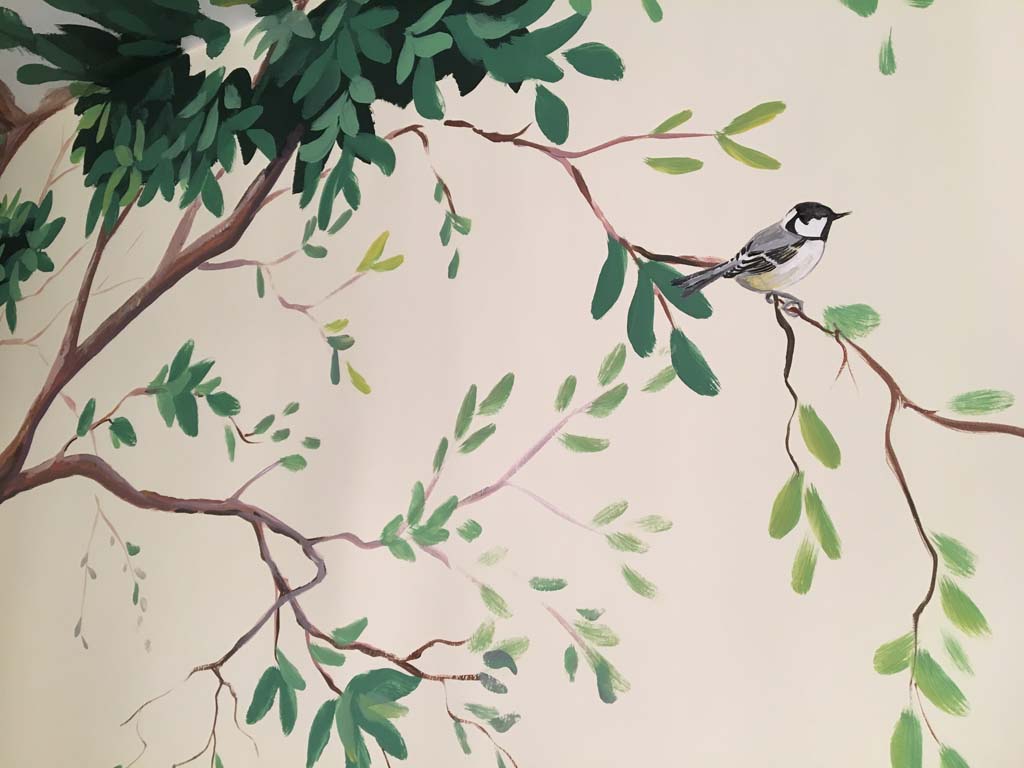 Coal tit on branch of a tree painted in a woodland wall mural